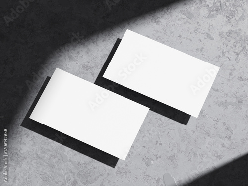 Clean and modern business card mockup on rough cement background.