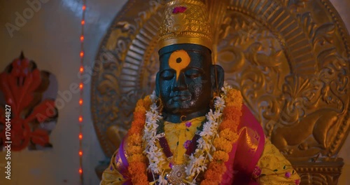 Sacred black stone idol of Lord Vitthal in the temple sanctum, radiating devotion and spirituality, symbolizing the essence of Hindu culture and divine faith