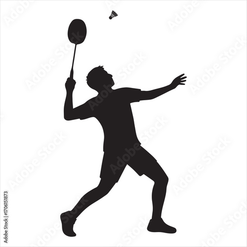 Silhouette of a male badminton player in action hitting a shuttlecock during a match