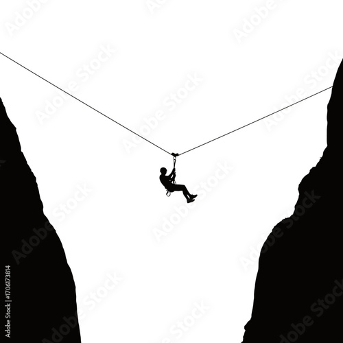 Silhouette of a person rappelling across a deep chasm between two dark rocky cliffs against a bright white sky