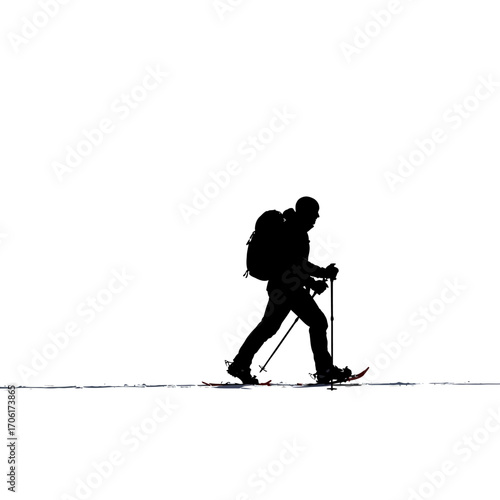 Silhouette of a lone hiker with a backpack walking across a snowy landscape with snowshoes and poles