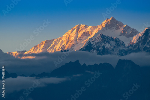 Beautiful last light from sunset on Mount Kanchenjugha, Himalayan mountain range, Sikkim, India. color tint on the mountains at dusk