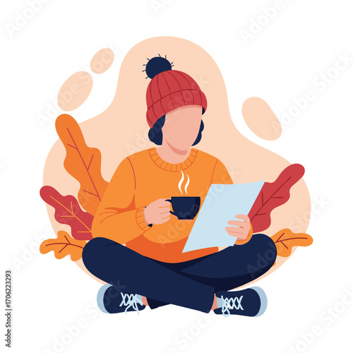 Person reading a book and drinking coffee in autumn.
