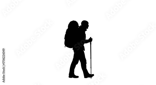 Silhouette of hiker with backpack walking with trekking pole