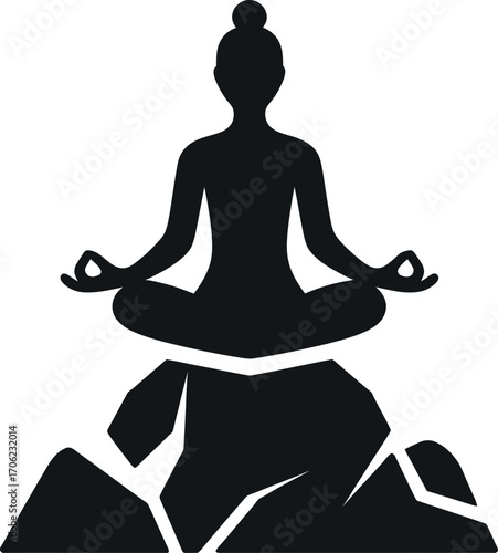 Silhouette of a person meditating on rocks in a peaceful and mindful setting