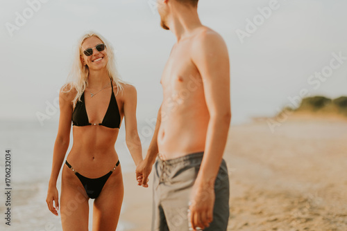 Couple enjoying a sunny bea...