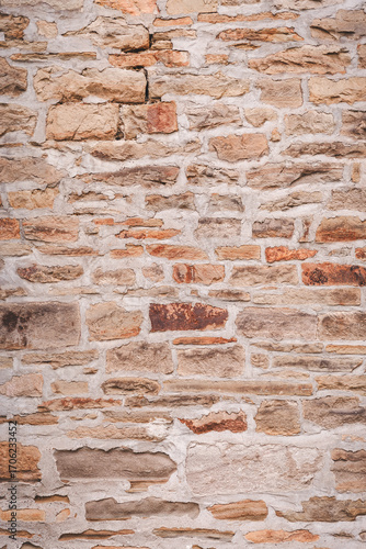 Rustic Natural Stone Masonry Wall Texture Background in Warm Colors