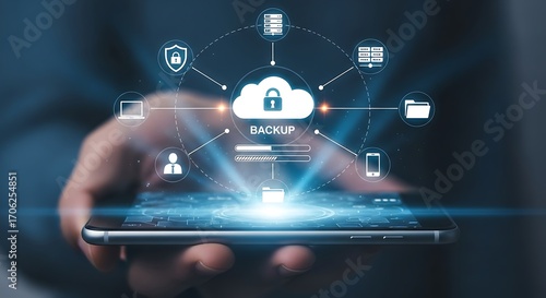 Wallpaper Mural A man is holding a smartphone with a cloud icon and a lock on the screen, representing data backup and security, with various other icons surrounding it, symbolizing technology Torontodigital.ca