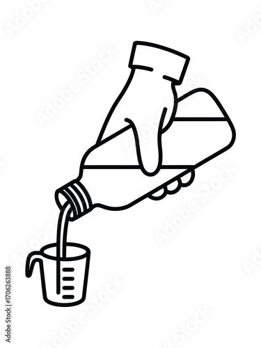Hand in glove pouring liquid from bottle into measuring cup