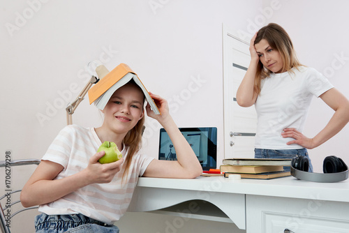 Mother and daughter fighting about homework, Upset mother is angry to little bored daughter, homeschooling, misunderstanding