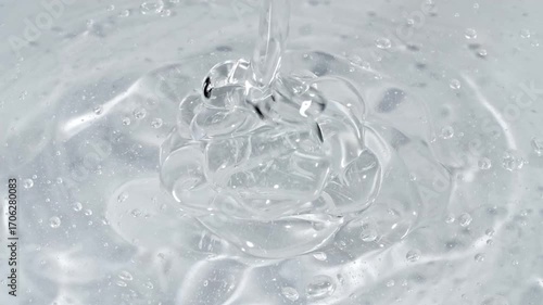 Closeup Shot of Clear Cosmetic Gel Fluid, Essential Oil With Molecule Bubbles Flowing on White Background. Macro Shot of Organic Products, Medicine. Dermatology Science Laboratory. . High quality 4k