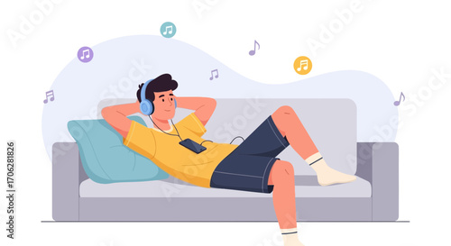 Relaxation And Music Enjoyment: A Young Man Listening Music At Home On The Couch Relaxed