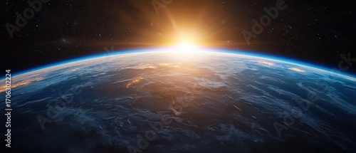 Fototapeta Naklejka Na Ścianę i Meble -  A breathtaking view of Earth from space, showcasing the curvature of the planet illuminated by a sunrise against a backdrop of stars.