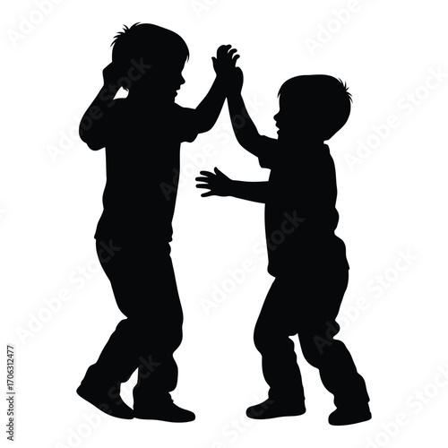 Two children silhouettes high fiving celebrating together joyful moment playful friendship silhouette