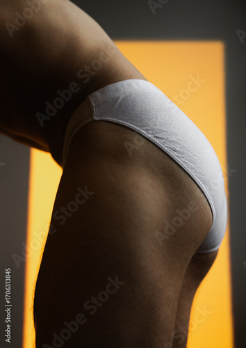 Male Body Part Detail in underwear With Yellow background
