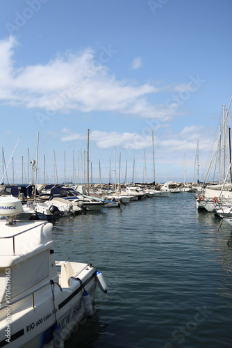 Yacht mooring in the harbor, yacht club harbor in Triet, Italy. Beautiful yachts against the blue sky