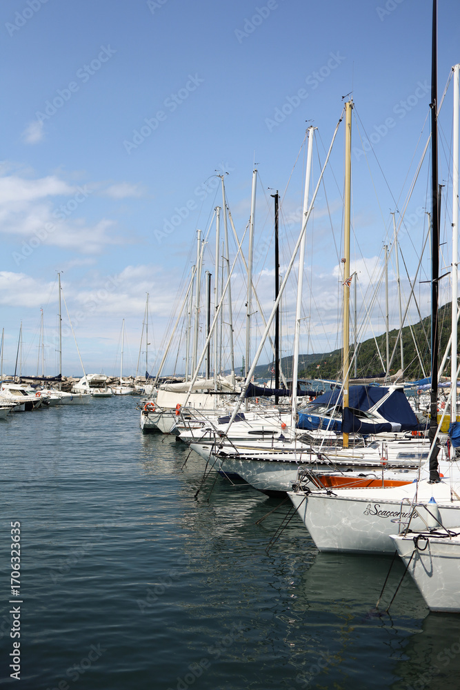 Obraz premium Yacht mooring in the harbor, yacht club harbor in Triet, Italy. Beautiful yachts against the blue sky