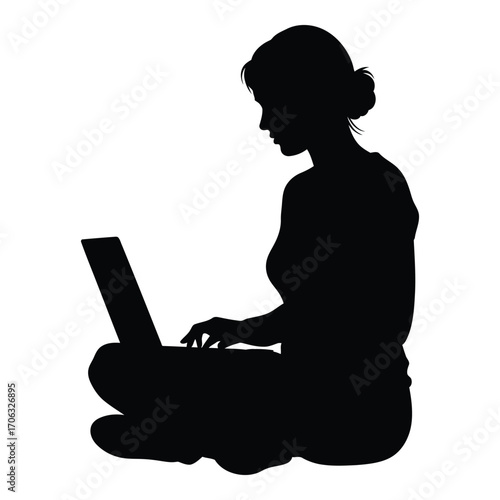 Silhouette of woman working on laptop in a sitting position with legs crossed silhouette