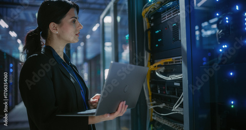 Wallpaper Mural Engineer using laptop computer in data center. Torontodigital.ca
