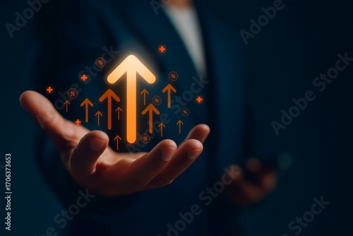 Business growth and success concept with glowing orange upward arrows in hand