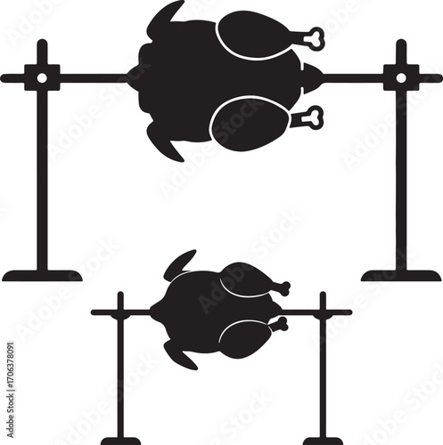 Two rotisserie chickens cooking on a spit silhouette