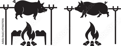 Two pigs roasting over open fires silhouette