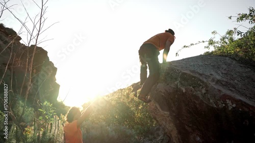 Traditional climbing with men warming up on rocks