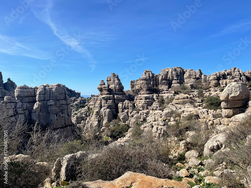 Majestic limestone formations towering over the landscape at Torcal de Antequera natural park in Andalusia, Spain, under a clear blue sky
