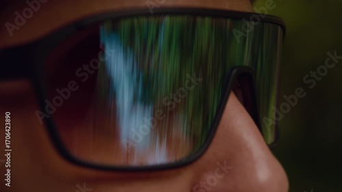 girl in sports glasses close-up reflection in glasses forest and river