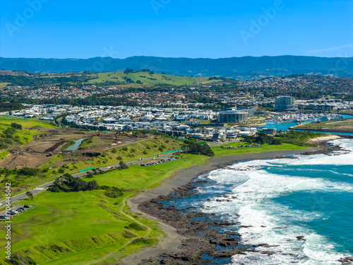 Drone aerial photograph of the rocky coastline of the South Pacific Ocean leading into the town of Shellharbour and Marina in the Illawarra region on the south coast of NSW, Australia.
