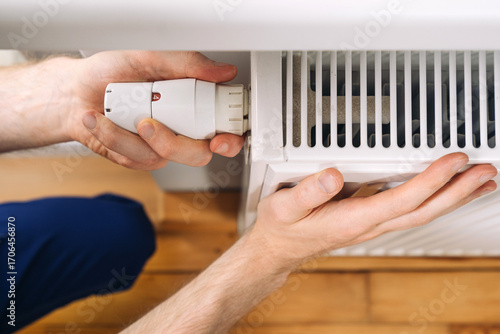 Home heating radiator maintenance with a plumber installing a new component