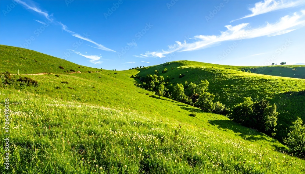 Obraz premium Lush green hills under a vibrant blue sky