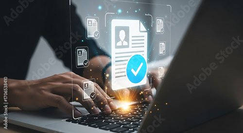 Close-up of person typing on laptop keyboard with digital approved document icons signifying file verification and recruitment process completion.