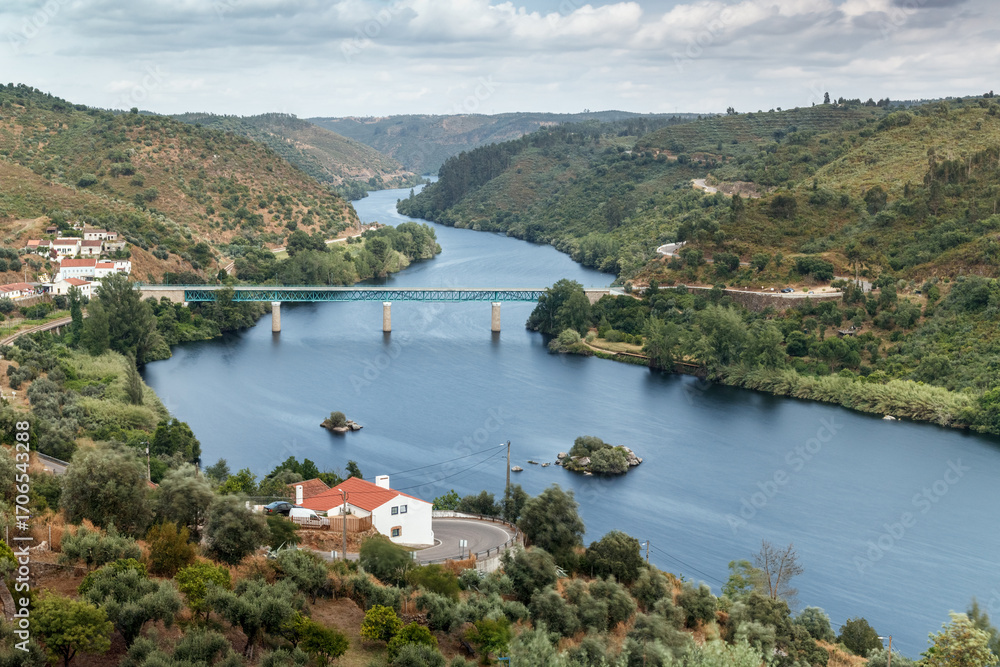 Fototapeta premium The Tagus river and road bridge seen upstream from Belver castle in Portugal.