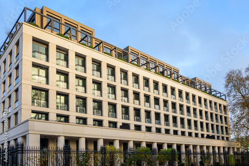 Exterior of a new luxury apartment building under clear sky at sunset in early December