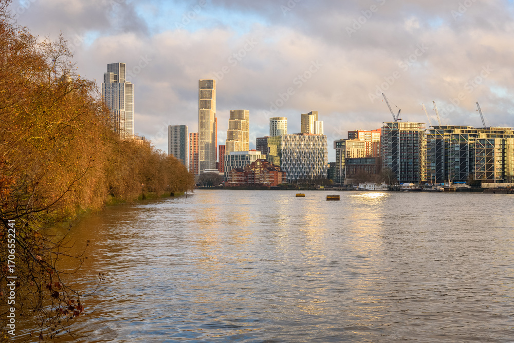Naklejka premium New high rise apartments on the bank of river Thames in London at sunset in in early December