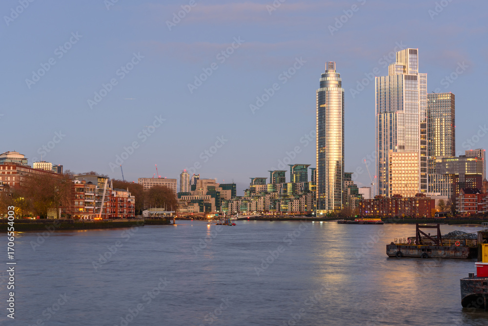Fototapeta premium London skyline as seen form Battersea Power Station riverside walk under clear sky at dusk in winter