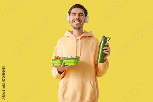 Young man in headphones wit...