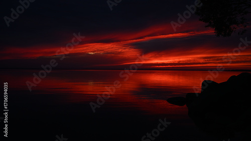 Fototapeta Naklejka Na Ścianę i Meble -  Dark red sunset over water