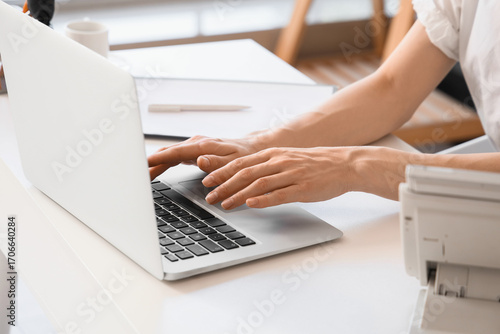 Photos Young secretary working with laptop in office, closeup