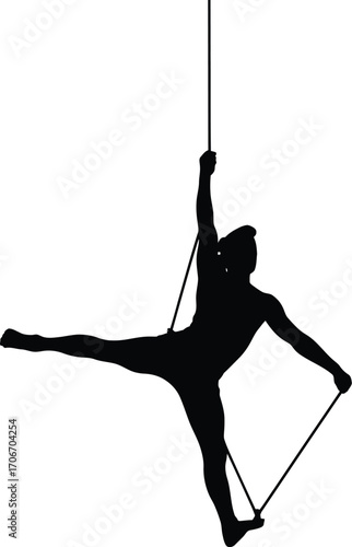 Graceful performer suspended on flowing aerial silks silhouette