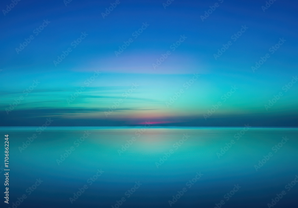 Obraz premium Abstract sunset over calm water with vibrant blue and teal hues