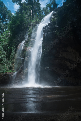Serene Waterfall Surrounded by Lush Greenery in Chiang Mai, Thailand