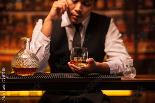 Wallpaper Mural Business man bartender pours whiskey into a glass, sitting sadly in a restaurant Torontodigital.ca