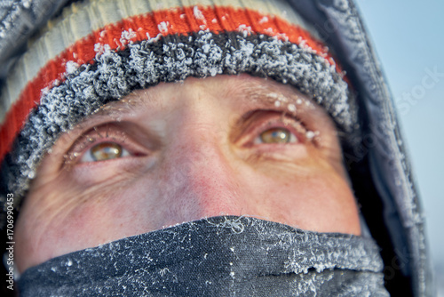 Close up frost man's face with mask covered by icy frost