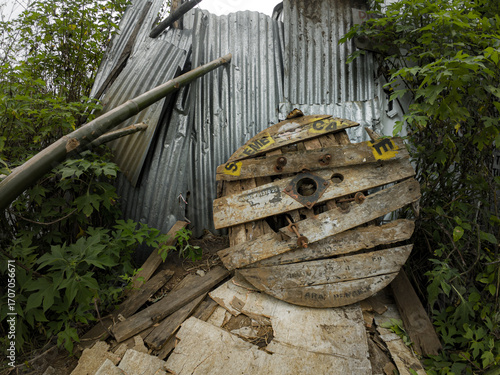 Abandoned Wooden Cable Reel and Scrap Metal Fence