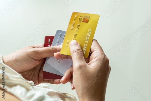 Billede på lærred Woman holding several credit cards and he is choosing a credit card to pay and spend Payment for goods via credit card