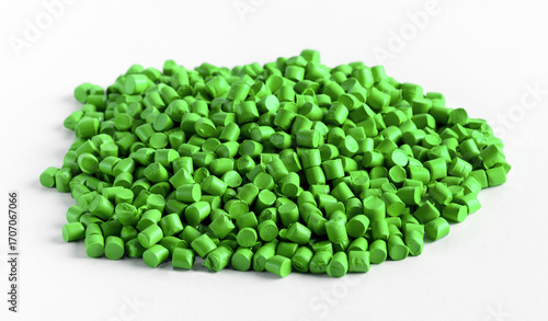 Green plastic granules forming a small pile on a white background