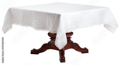 Square wooden table covered with an intricate white linen tablecloth with lace trimming, isolated on white, casting a soft shadow below