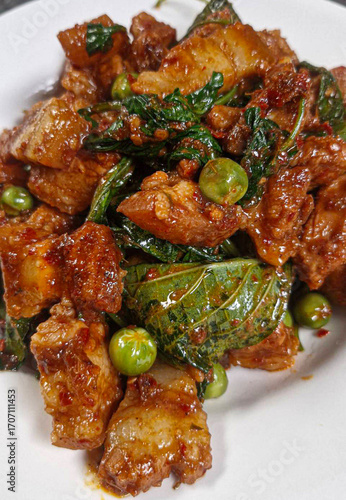 Stir-fried pork belly with curry paste. Pork belly stir-fried with curry paste. Thai food. Spicy. Pork with herbs. Thai food. Pork. Spices. Herbs   